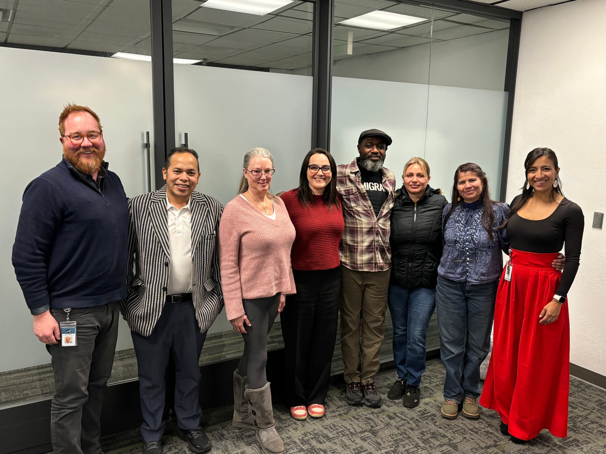 Community Connectors-in-Residence, City staff, and Councilmember Nicole Speer stand in a line and smile at the camera.