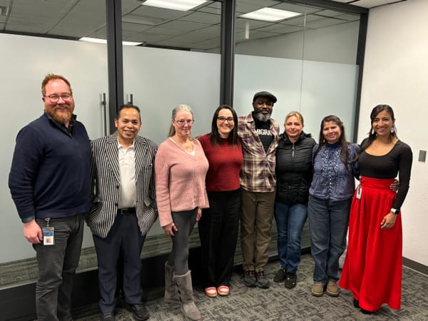 Community Connectors-in-Residence, City staff, and Councilmember Nicole Speer stand in a line and smile at the camera.