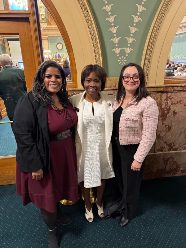 Martha Wilson, Rep. Junie Joseph, and Councilmember Nicole Speer pose in front of the House chamber at the state Capitol.